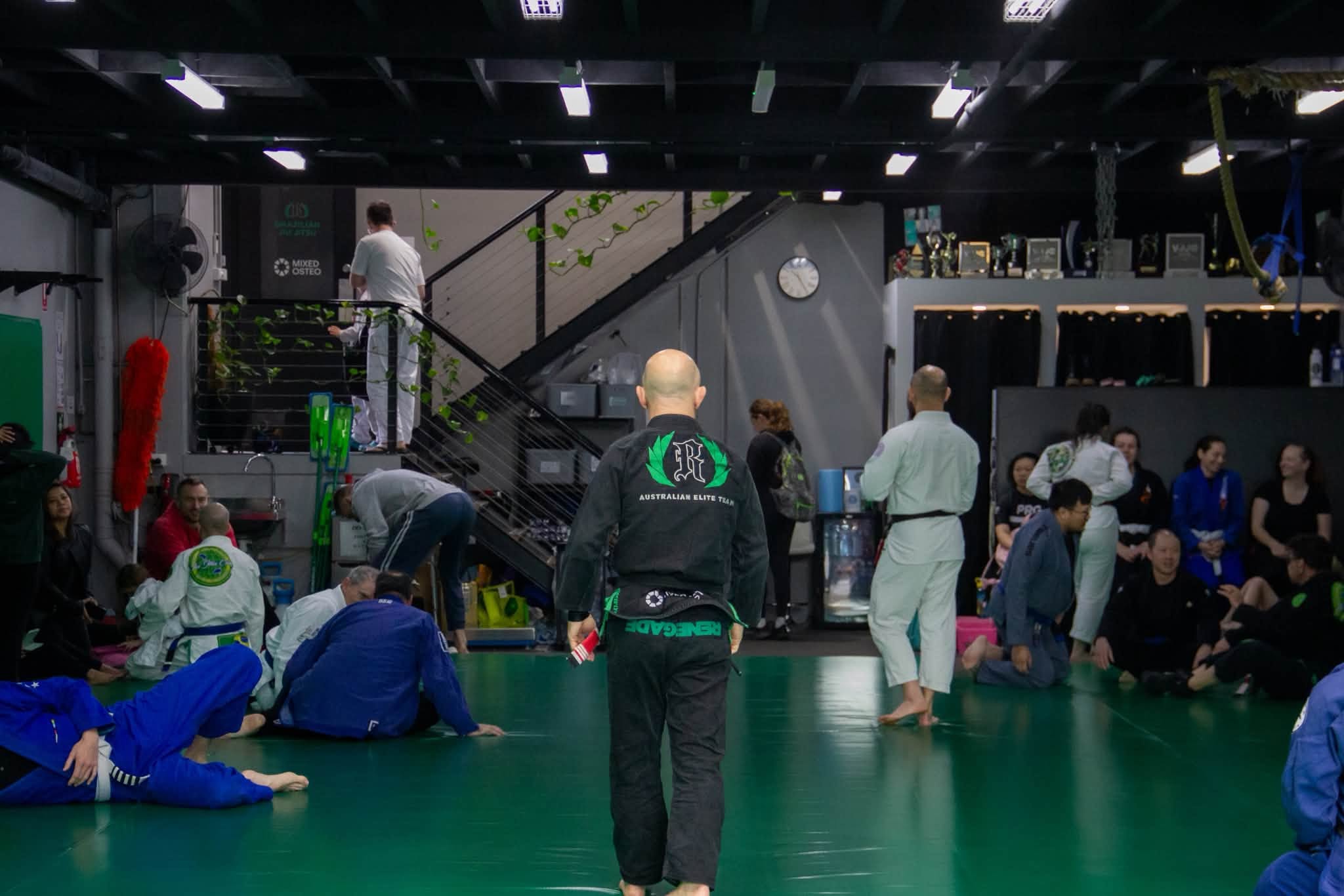 Members on the mats before a class at Renegade BJJ